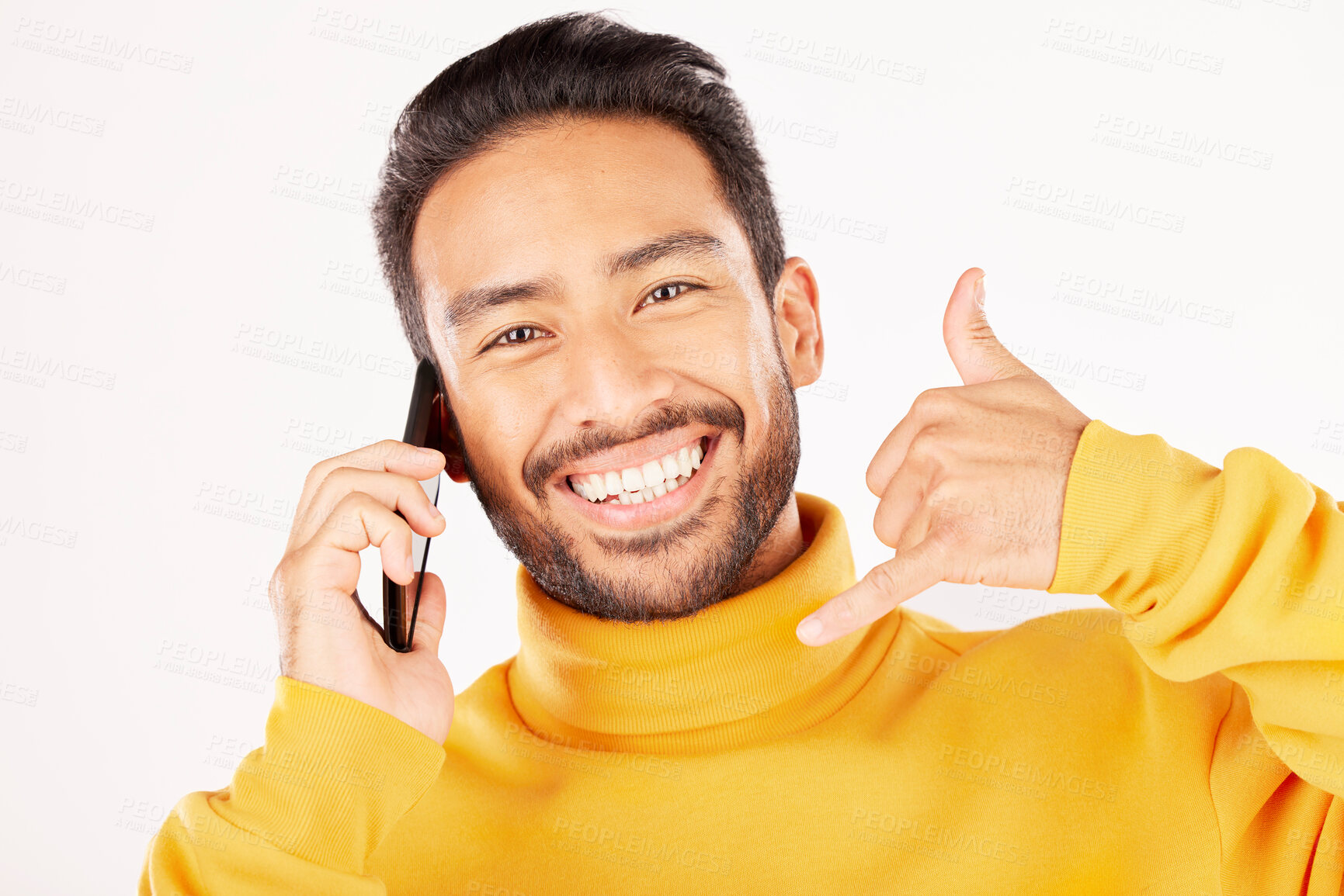 Buy stock photo Man, phone call and hand sign with a smile in studio for flirting or communication portrait. Face of a happy asian person talking on a smartphone with contact us emoji isolated on a white background