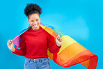 African woman, pride flag and smile in studio, thinking and excited for human rights, equality and inclusion. Girl, student and rainbow fabric for protest, freedom and lgbtq vision by blue background