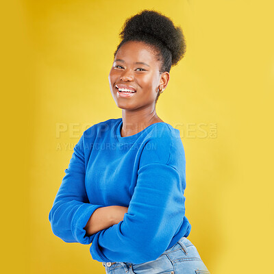 Buy stock photo Portrait, smile and arms crossed with a black woman on a yellow background in studio for fashion. Happy, confident and proud with a happy young person posing for trendy style in a clothes outfit