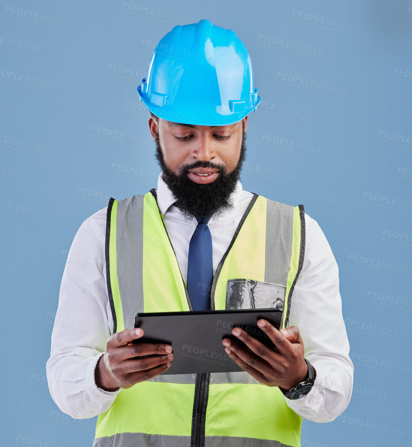 Buy stock photo Black man, architect and tablet for construction inspection or planning against a blue studio background. African male person, engineer or contractor working on technology for industrial architecture