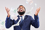 Money, rain and happy black man in studio for savings, growth or cashback bonus on blue background, Cash, shower and African guy winner with investment, success or financial freedom award celebration