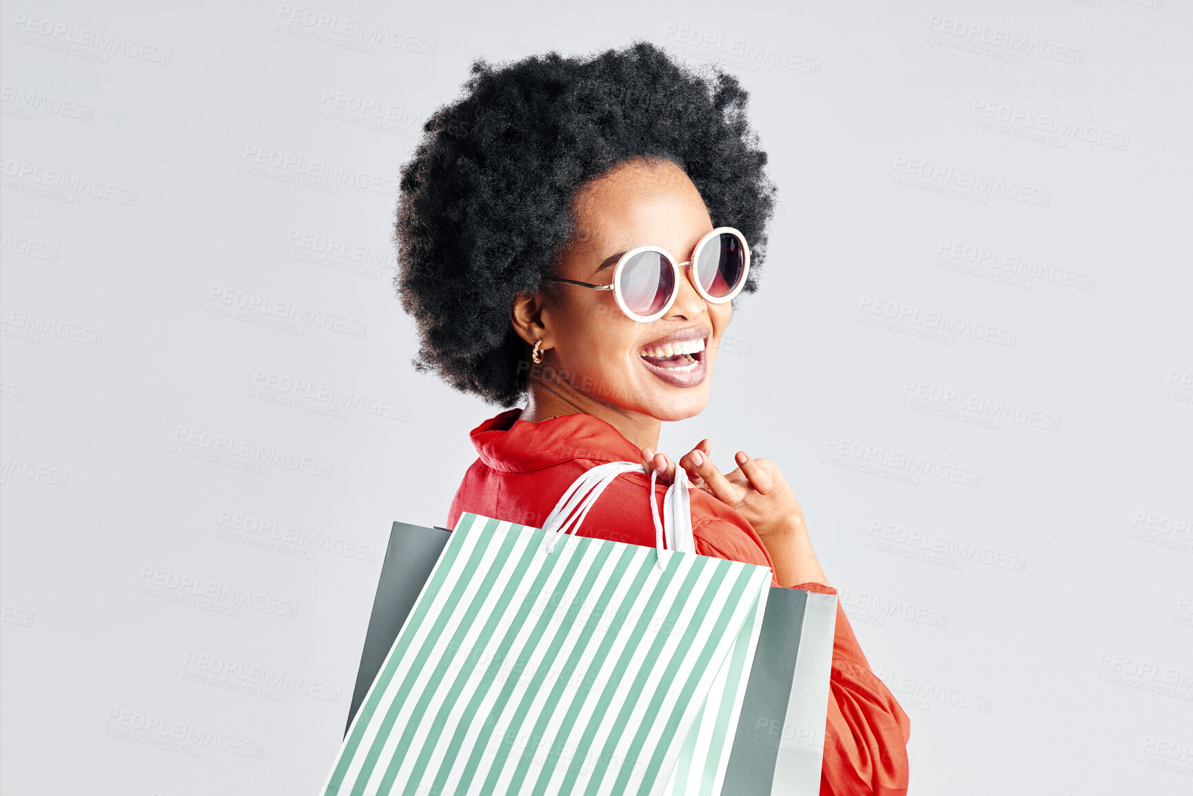 Buy stock photo Happy black woman, afro and shopping bags for discount, sale or fashion deal against a white studio background. Portrait of African female person, customer or shopper smile for purchase in happiness