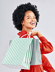 Shopping bag, happy portrait and woman with fashion discount, sale and retail promotion on a white background. Gift, giveaway and young customer, model or african person with clothes in studio