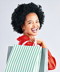 Shopping bag, portrait and woman excited for fashion discount, cosmetics sale in retail on a white background. Gift, beauty giveaway and young customer, model or african person laughing in studio