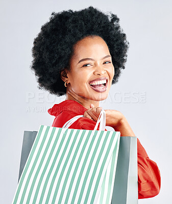 Buy stock photo Shopping bag, portrait and woman excited for fashion discount, cosmetics sale in retail on a white background. Gift, beauty giveaway and young customer, model or african person laughing in studio