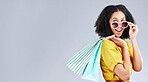 Shopping, bag and woman excited for retail sale, promotion or happy for discount on studio, mockup or grey background. Wow, customer and girl to shop for fashion or sales on luxury clothing