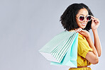 Shopping, bag and woman happy for retail sale, promotion or excited for discount on studio, mockup or grey background. Customer, portrait or girl to shop for fashion or sales on luxury clothing