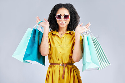 Buy stock photo Sunglasses, portrait and happy woman with shopping bag for fashion in studio isolated on a white background. Cool, sales and African customer with gift, discount deal and stylish clothes from store