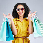 Portrait, sunglasses and woman with shopping bags for fashion in studio isolated on a white background. Face smile, sales and African customer with gift, discount deal and stylish clothes from store