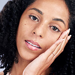 Beauty, woman and hand on face for skin care, dermatology and cosmetics or natural makeup. Closeup portrait of young african female model in studio for facial shine, glow and soft touch for self love