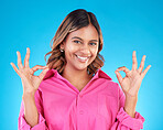 Woman, hands and OK sign with portrait, agreement and positive feedback vote isolated on blue background, Happy female person, like emoji and success with support, hand gesture and review in studio