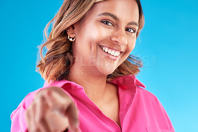 Buy stock photo Woman, pointing finger and smile portrait in studio for beauty, advertising and choice. Face of a happy model person with hand or emoji for accountability, decision or choosing you on blue background