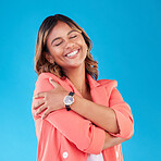 Professional, hug and business woman in studio for self love, support and care with confidence. Corporate, happy and female person embrace for positive mindset, pride and happiness on blue background
