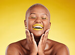 Happy, gold makeup and a black woman on a studio background for creativity, skincare and beauty. Laughing, wellness and an African model or girl with lipstick isolated on a backdrop for an aesthetic
