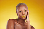 Skincare, makeup and portrait with african girl for glow in yellow studio, background or luxury spa. Serious, cosmetics and woman with hand on face for dermatology with natural beauty or wellness.