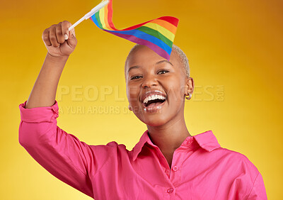 Buy stock photo Flag, pride and portrait of black woman with support of the lgbtq community isolated in a studio yellow background. Smile, happy and gen z or young gay person with rainbow symbol of equality