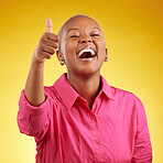 Laughing, black woman and thumbs up in studio for vote, review or positive feedback on yellow background. Yes, hand and happy African female with emoji for choice, thank you or decision support