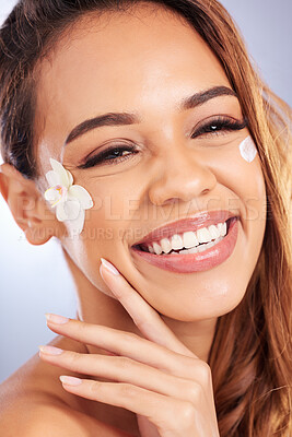 Buy stock photo Cosmetics, portrait of happy woman with flower and cream on face, natural makeup and spa treatment on white background. Skincare, beauty and smile, model with floral and organic facial care in studio