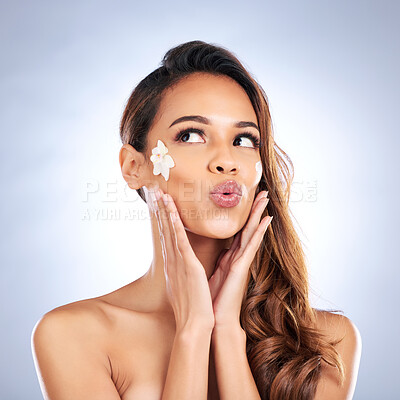 Buy stock photo Beauty, kiss and woman with flower on face, natural makeup and spa treatment glow on white background. Dermatology, skincare and nature, happy model with floral and organic facial cosmetics in studio