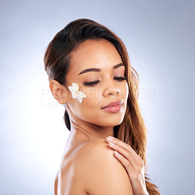 Buy stock photo Beauty, skincare and woman with flower on face, natural makeup and spa treatment on white background. Dermatology, skin care glow and nature, model with floral and organic facial cosmetics in studio.
