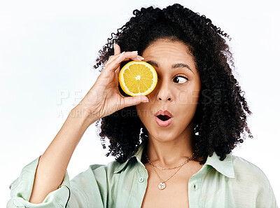 Buy stock photo Vitamin c, lemon and eye of shocked woman with fashion for organic wellness isolated in a studio white background. Diet, fruit and healthy or excited young person with crazy citrus energy and detox