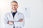 Senior man, optometrist and portrait, arms crossed and smile, eye care clinic and healthcare with vision. Male person, ophthalmology and health for eyes, eyesight assessment and prescription glasses