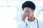 Headache, doctor and stress with black woman at the hospital, clinic or working with burnout, fatigue or pain in head. Frustrated, person and problem with mental health, healthcare or migraine