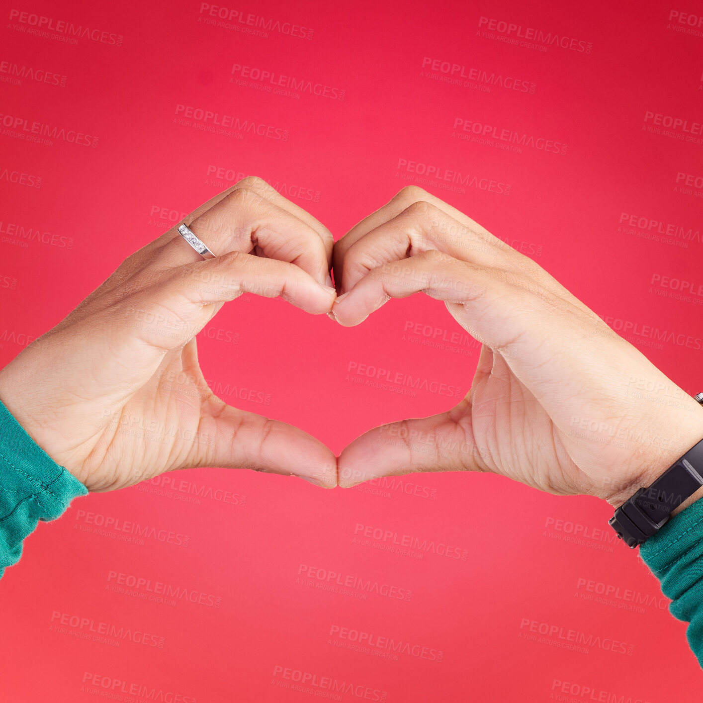 Buy stock photo Closeup, person and heart hands for love, care or compassion against a red studio background. Hand together in loving emoji, shape or symbol for romantic gesture, icon or valentines day