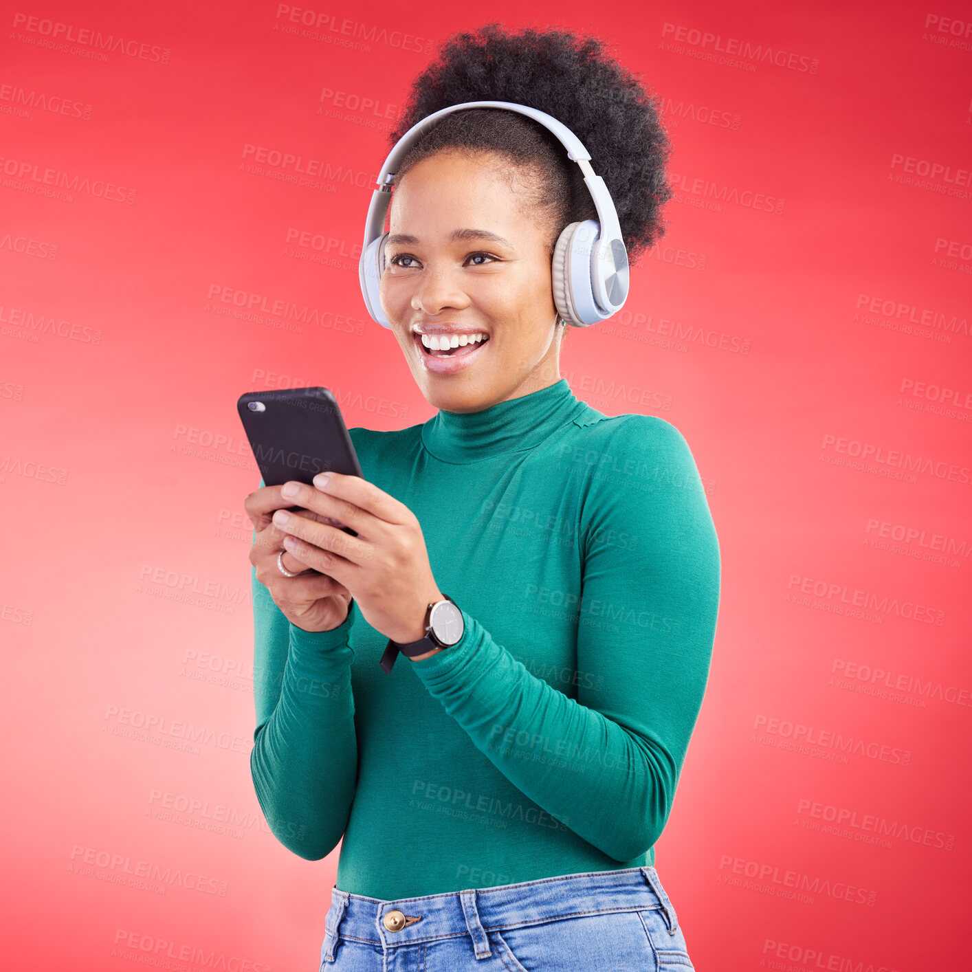 Buy stock photo Happy woman, phone and listening to music on headphones against a red studio background. African female person smile with headset in audio streaming, entertainment or sound track on mobile smartphone