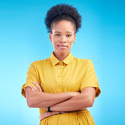 Buy stock photo Arms crossed, portrait and a black woman in studio with fashion, confidence and a positive mindset. Pride, smile and african female model person in casual clothes on a blue background for motivation