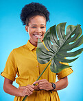 Fashion, portrait and black woman with plant on blue background for cosmetics, makeup and beauty. Nature, studio and female person with monstera leaf for organic, natural and detox wellness products