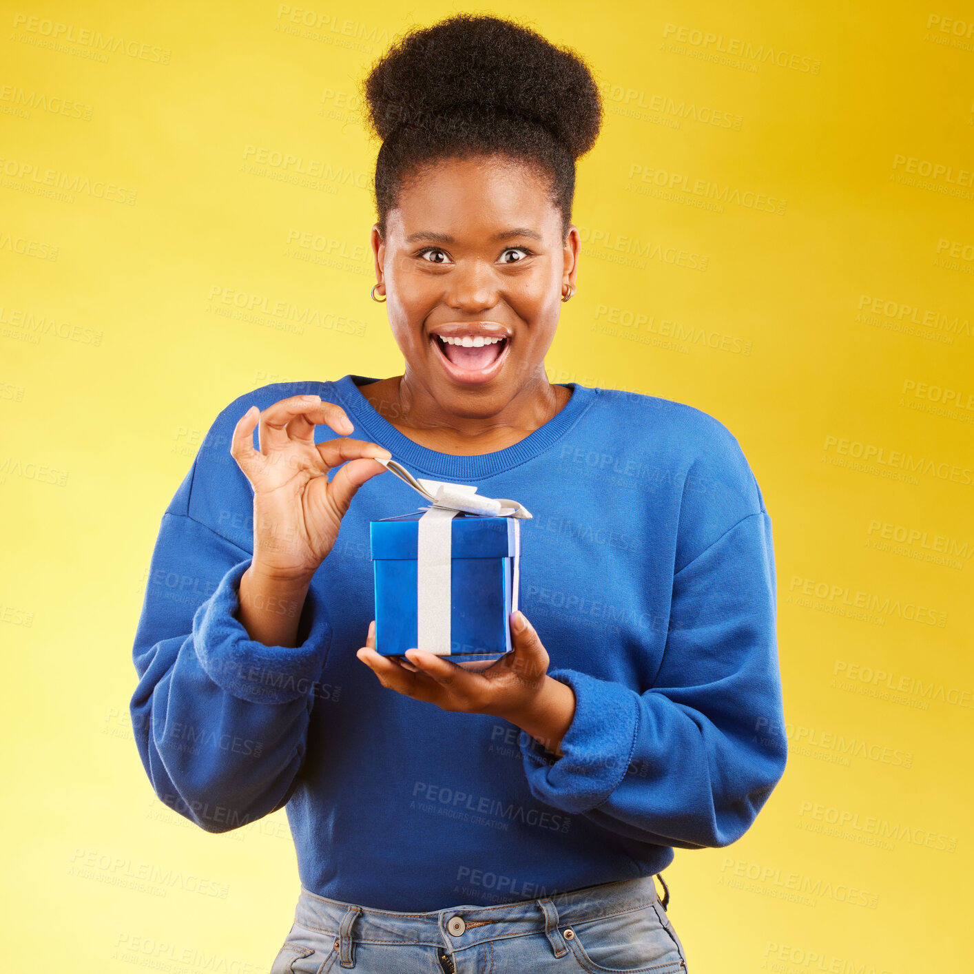 Buy stock photo Gift, present and portrait of black woman with a surprise happy isolated in a yellow studio background for a birthday. Shocked, box and excited person to celebrate, party and holiday as a winner
