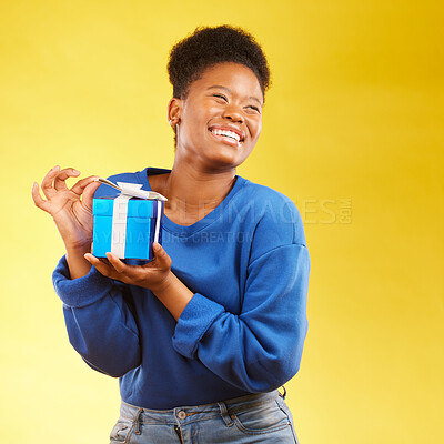 Buy stock photo Gift, winning and happy black woman with a surprise isolated in a yellow studio background for a birthday. Giveaway, box and excited person to celebrate, party and holiday as a winner with happiness