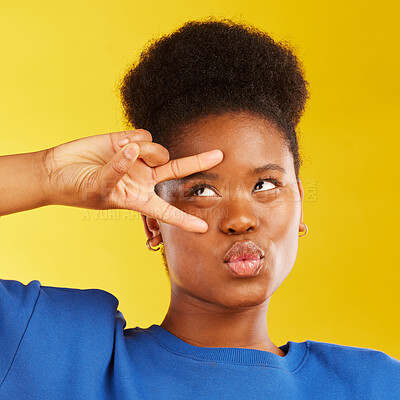 Buy stock photo Peace, hand sign and a black woman in studio with pouting lips, confidence and a positive mindset. Emoji, icon and face of african female model person on yellow background with a v symbol and freedom
