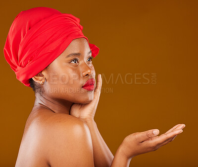 Buy stock photo Beauty, makeup and presentation with face of black woman in studio for cosmetics, creative and show. Skincare, salon and mockup with female model on brown background for wellness, self care and glow