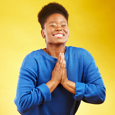 Buy stock photo Thank you, hands and black woman praying in studio happy, relief and grateful on yellow background. Blessing, gratitude and African female smile for good news, outcome or results, solution or answer