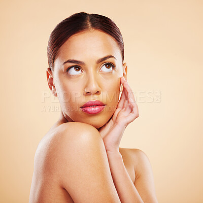 Buy stock photo Face touch, beauty skincare and woman in studio isolated on a brown background mockup space. Cosmetic, natural and model thinking of spa facial treatment for dermatology, aesthetic and skin wellness