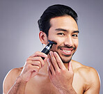 Beard hair trimmer, portrait or man smile for bathroom shaving routine, hygiene grooming or morning skincare. Razor, facial growth maintenance or studio person with clean face glow on gray background