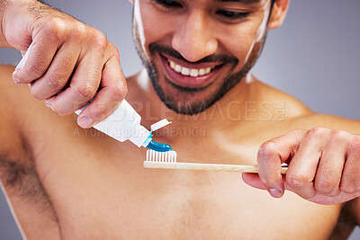 Buy stock photo Toothpaste, dental or happy man brushing teeth with smile or healthy oral hygiene grooming in studio. Eco friendly, tube product or male model cleaning mouth with a natural bamboo wood toothbrush 