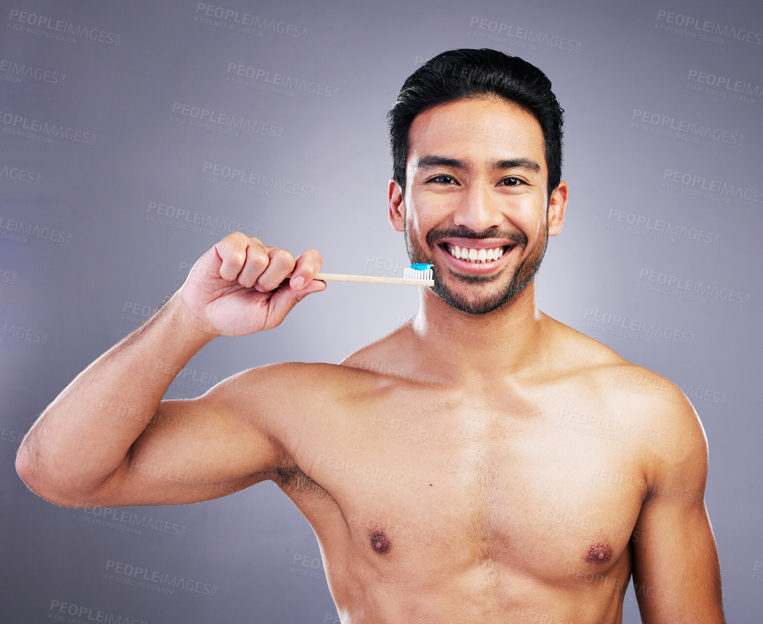 Buy stock photo Dental, portrait and a man brushing teeth on a studio background for cleaning, grooming and hygiene. Happy, wellness and an Asian person with a toothbrush for care of mouth isolated on a backdrop
