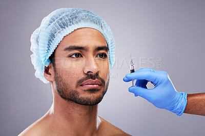 Buy stock photo Hand, face and plastic surgery with a man in studio on a gray background for silicon injection. Facelift, beauty and transformation with a male customer in a clinic for antiaging filler or cosmetics