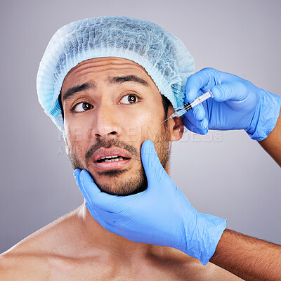 Scared, man or plastic surgery injection for facelift or cosmetics isolated in studio on white background. Hands, fear or worried Asian male person with needle for skin beauty in medical procedure