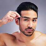 Tweezer, eyebrow and portrait of a man in studio for beauty, hygiene or grooming. Facial hair removal, epilation and face of asian person for skincare, self care and cosmetic tools on grey background