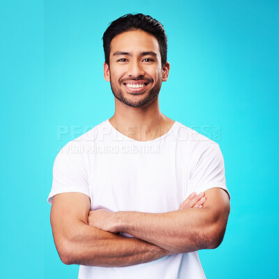 Buy stock photo Smile, confident and portrait of Asian man arms crossed with casual fashion isolated in a studio blue background. Relax, calm and young male person with cheerful or happy mindset and happiness