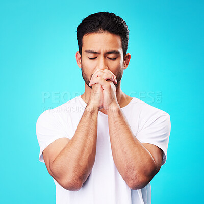 Buy stock photo Man, praying and hands in meditation or worship to God for faith or belief in spirituality, mindfulness and peace in studio. Christian, prayer and person with religion and zen on blue background