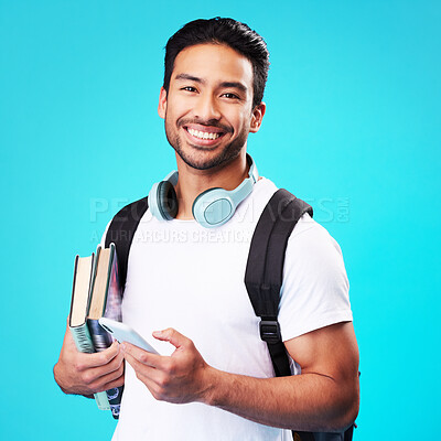 Buy stock photo Indian, college student and portrait with phone in studio and backpack for university, education and connection on blue background. Happy, man and person excited to study and learn for future goals