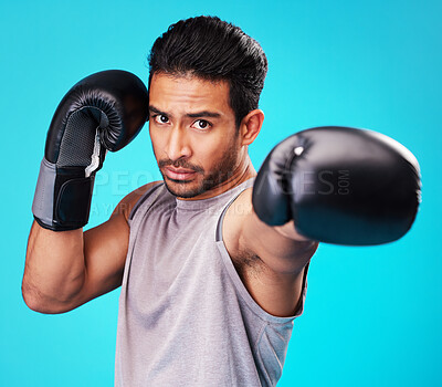 Buy stock photo Portrait, man and training with boxing, punch and sports 
challenge against a blue studio background. Male person, competition and serious boxer with power, strong or energy with exercise or fighting