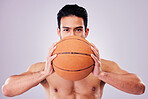 Portrait, exercise and basketball with a sports man in studio on a gray background for training or a game. Fitness, workout or focus and a young shirtless male athlete holding a ball with confidence