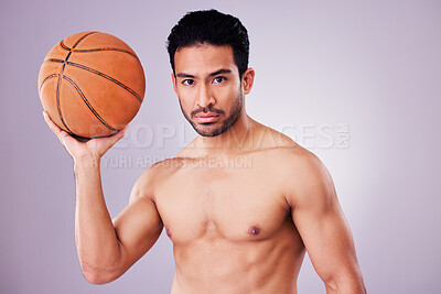 Buy stock photo Portrait, basketball and focus with a sports man in studio on a gray background for training or a game. Fitness, body or shirtless and a young male athlete holding a ball with focus or confidence