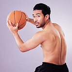 Sports, exercise and basketball with a man playing in studio on a gray background for training or a game. Exercise, workout or shirtless and a young male athlete holding a ball for competition